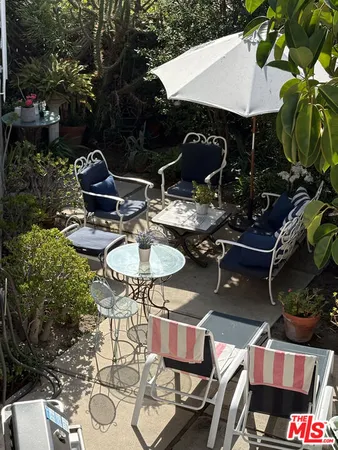 a backyard of a house with table and chairs