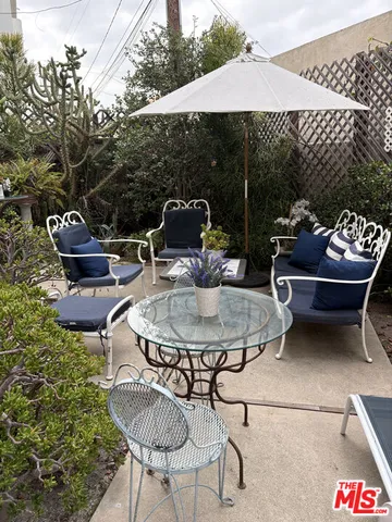 a backyard of a house with table and chairs