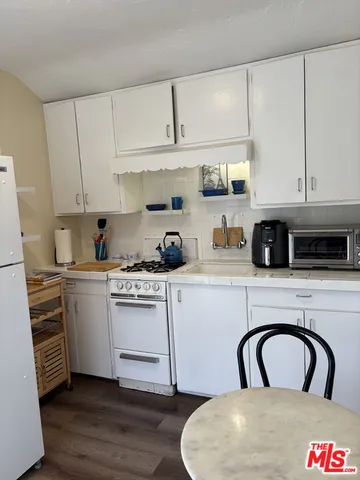a kitchen with a white cabinets and white appliances