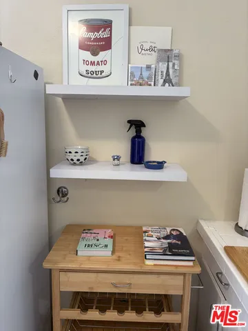 a utility room with a stove and wooden floor
