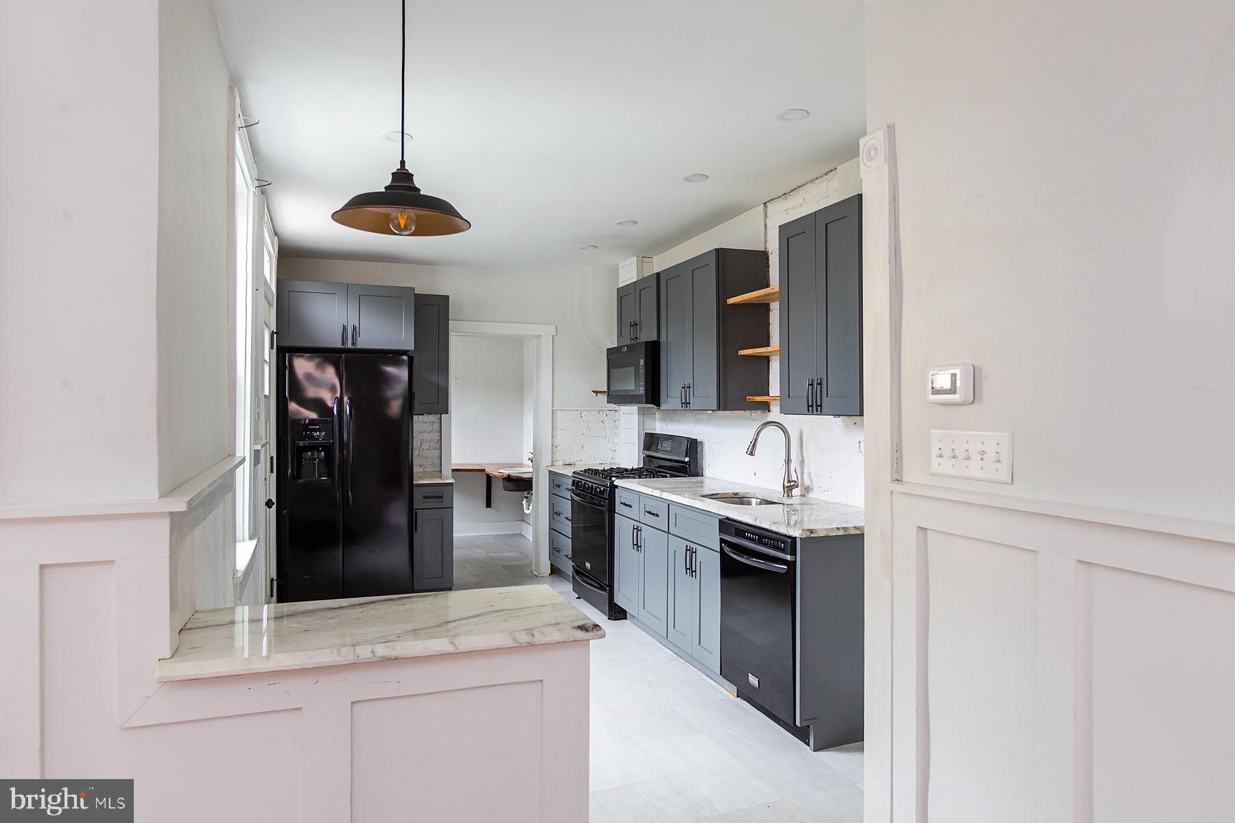 138 Laurel Street Lancaster, PA 17603 - Photo 11 of 42 a kitchen with a sink a stove and refrigerator