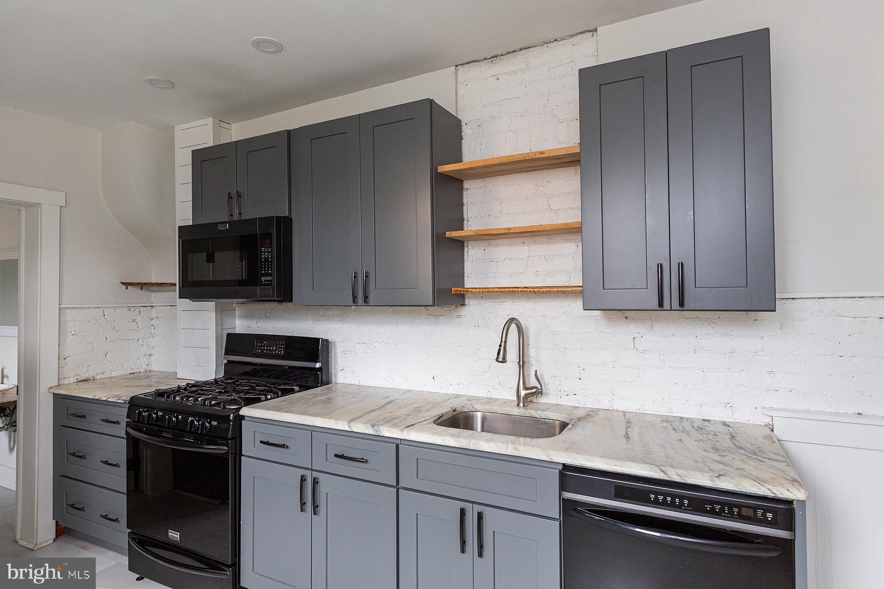 138 Laurel Street Lancaster, PA 17603 - Photo 13 of 42 a kitchen with a sink stove and microwave