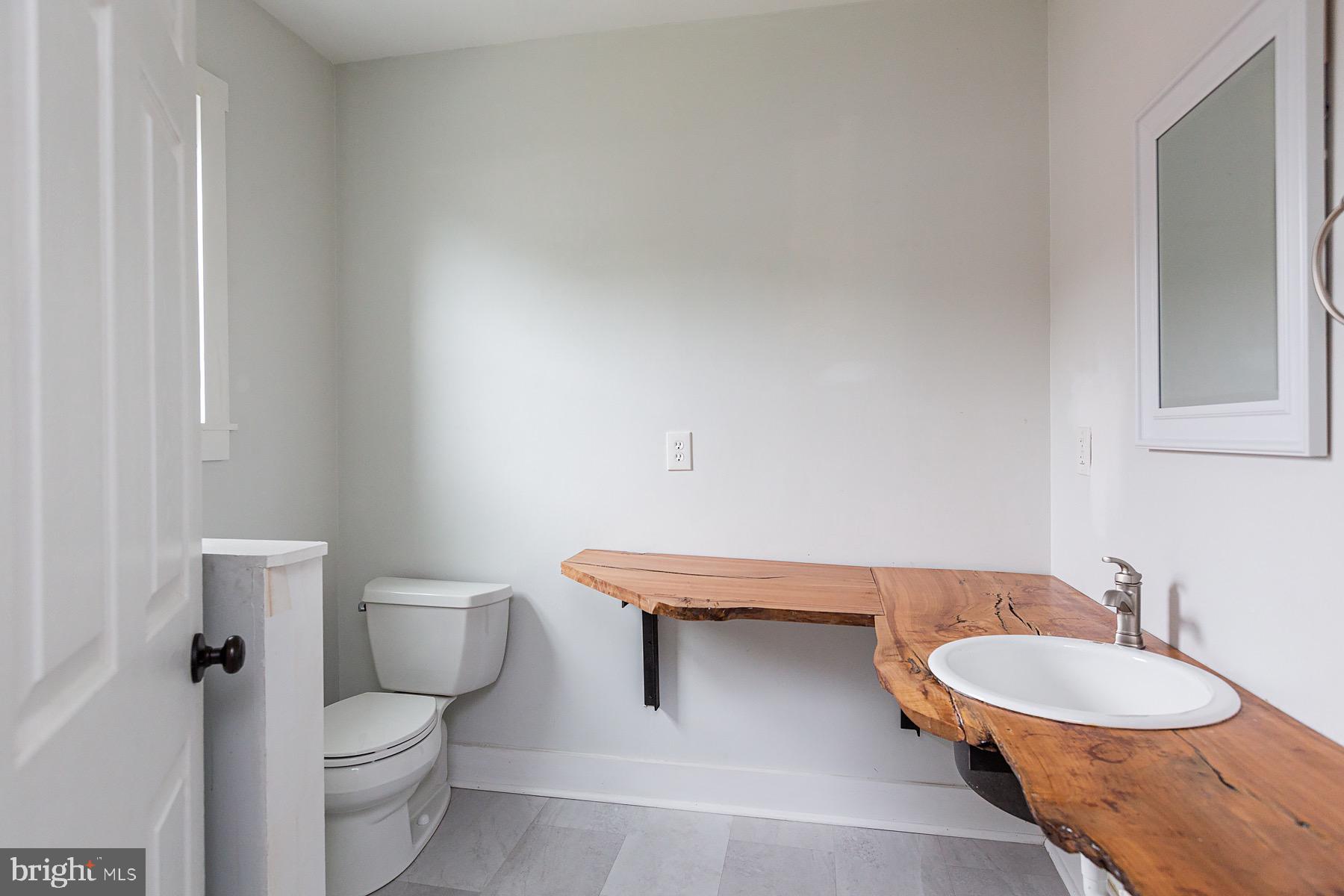 138 Laurel Street Lancaster, PA 17603 - Photo 17 of 42 a bathroom with a toilet a sink and mirror