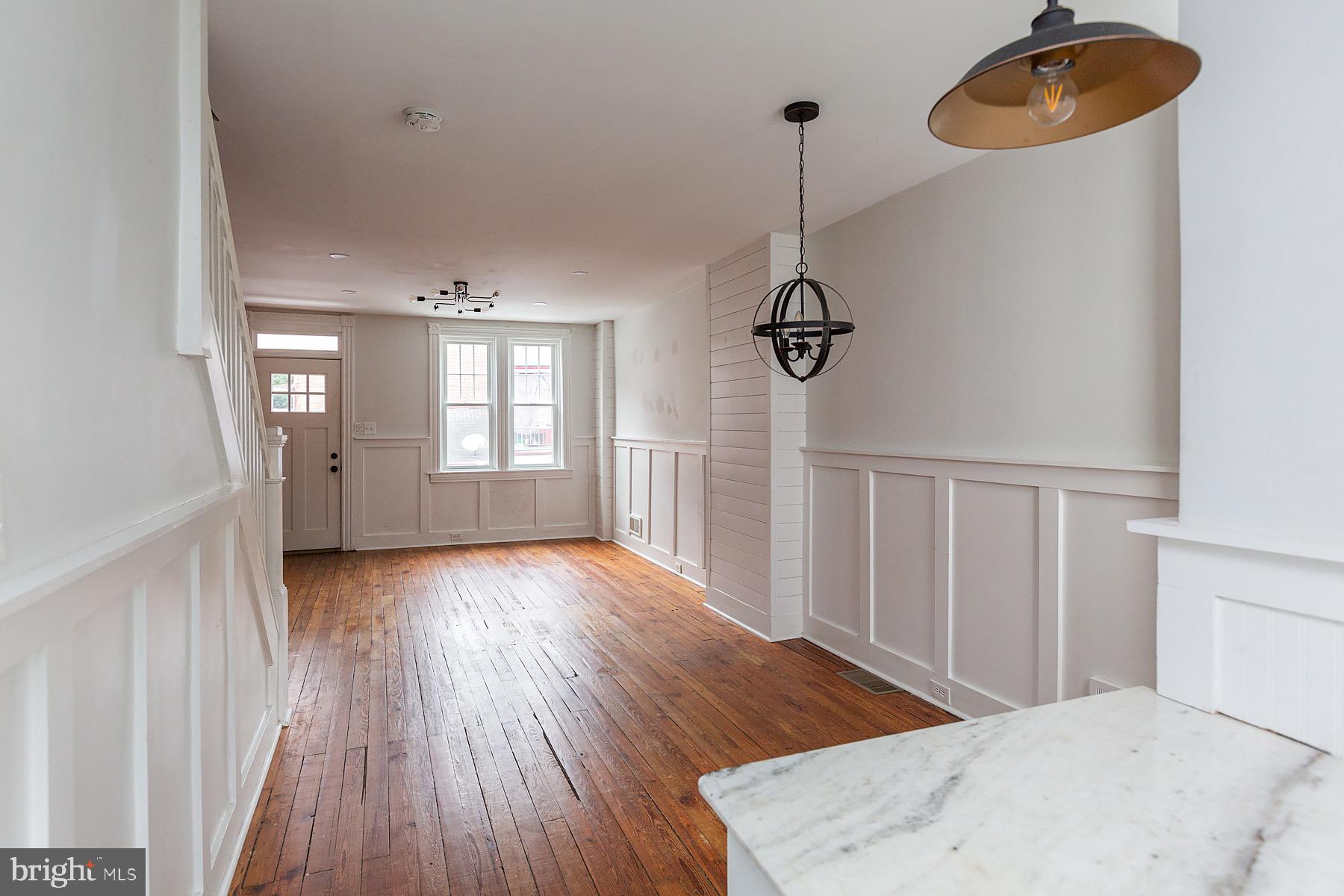 138 Laurel Street Lancaster, PA 17603 - Photo 20 of 42 a view of an empty room with wooden floor and a window