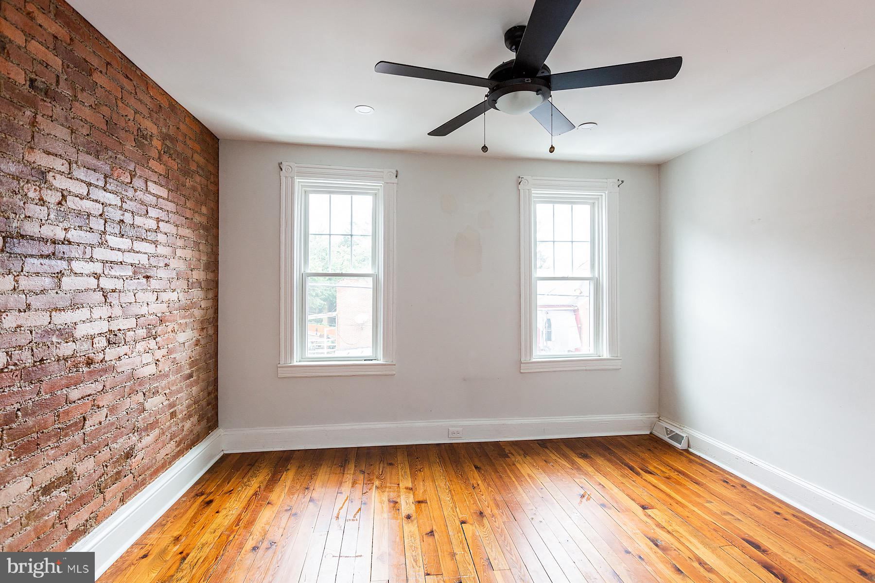 138 Laurel Street Lancaster, PA 17603 - Photo 24 of 42 a view of an empty room with wooden floor and a window