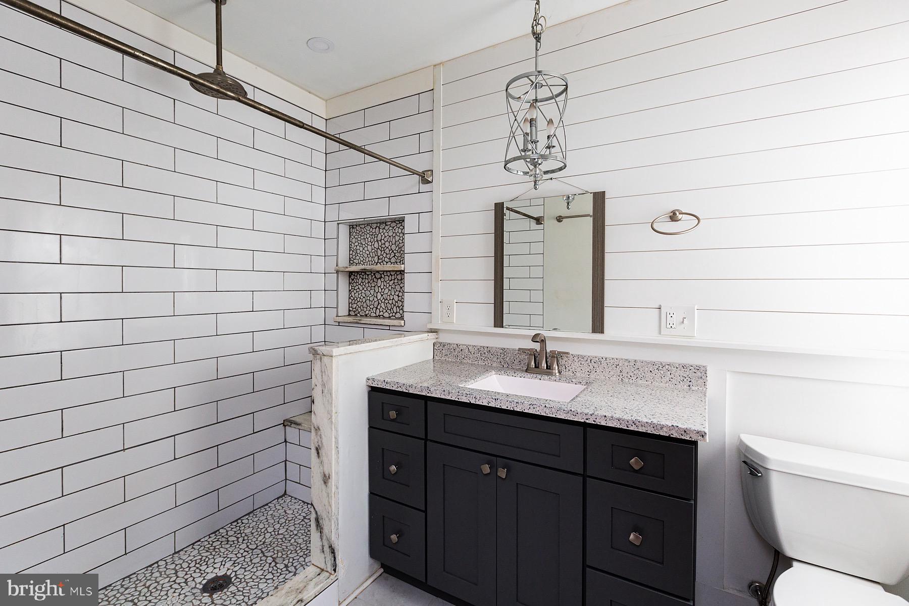 138 Laurel Street Lancaster, PA 17603 - Photo 32 of 42 a bathroom with a sink a toilet and mirror