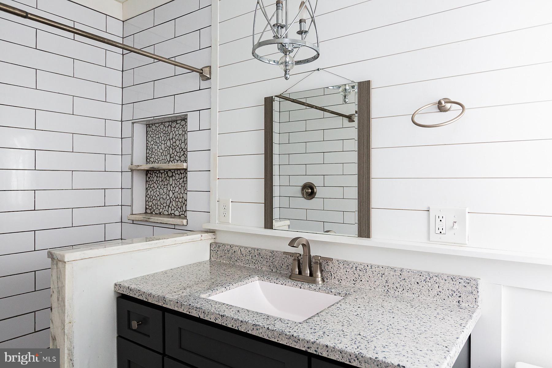 138 Laurel Street Lancaster, PA 17603 - Photo 33 of 42 a bathroom with a granite countertop sink and a mirror