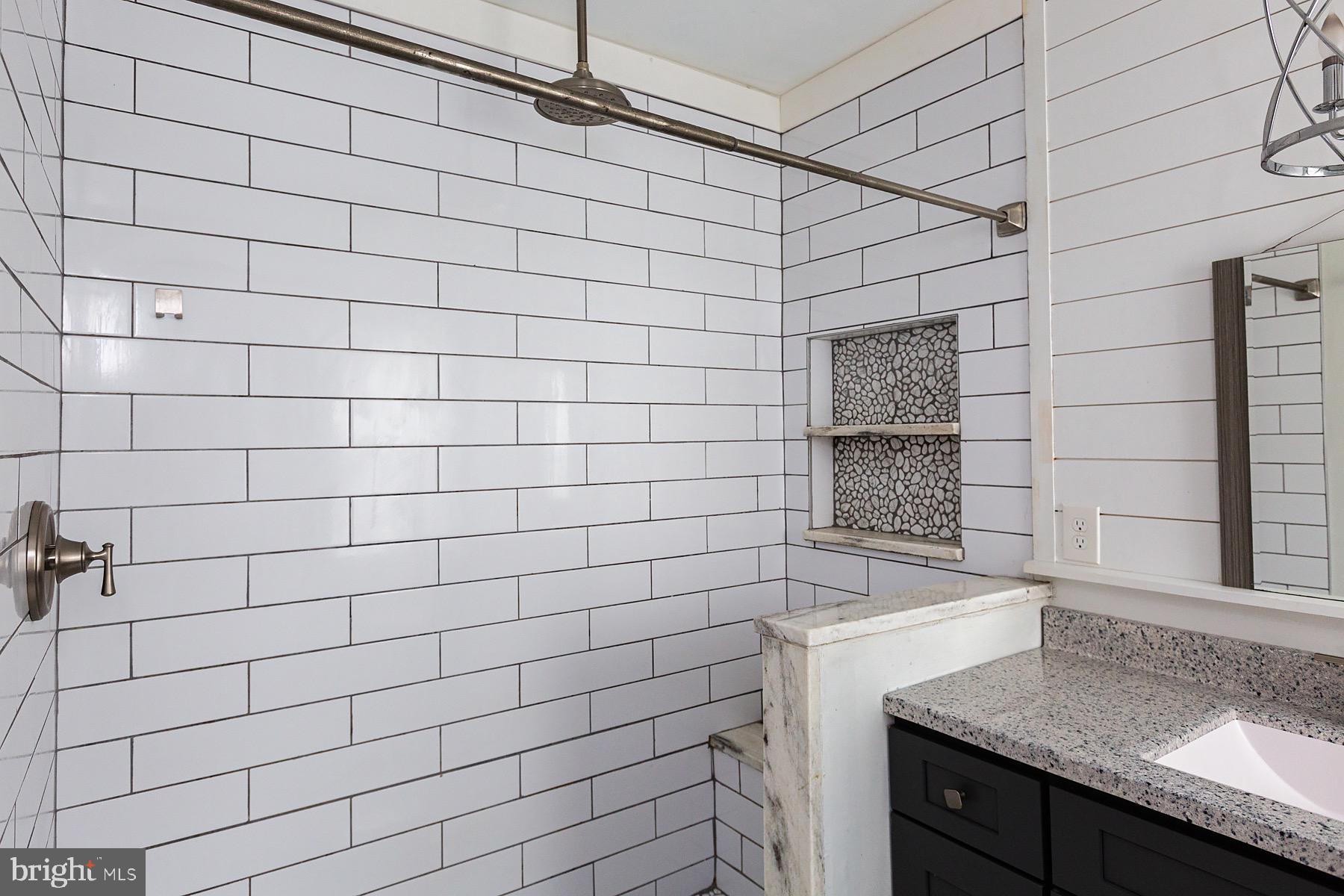 138 Laurel Street Lancaster, PA 17603 - Photo 37 of 42 a bathroom with a granite countertop sink and mirror