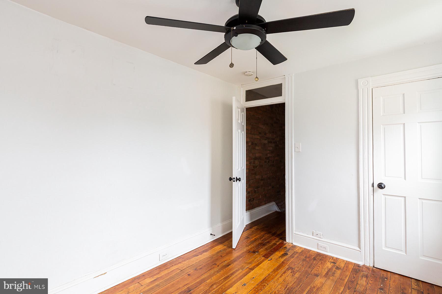 138 Laurel Street Lancaster, PA 17603 - Photo 39 of 42 an empty room with wooden floor a ceiling fan and a ceiling fan