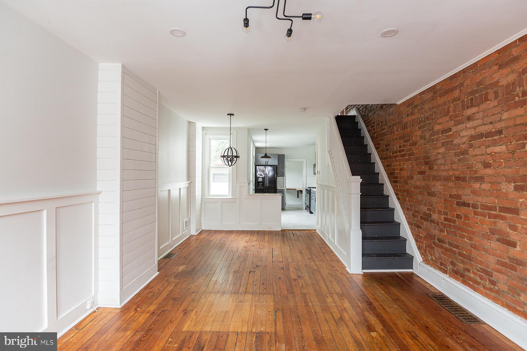 138 Laurel Street Lancaster, PA 17603 - Photo 4 of 42 a view of a hallway with wooden floor and staircase