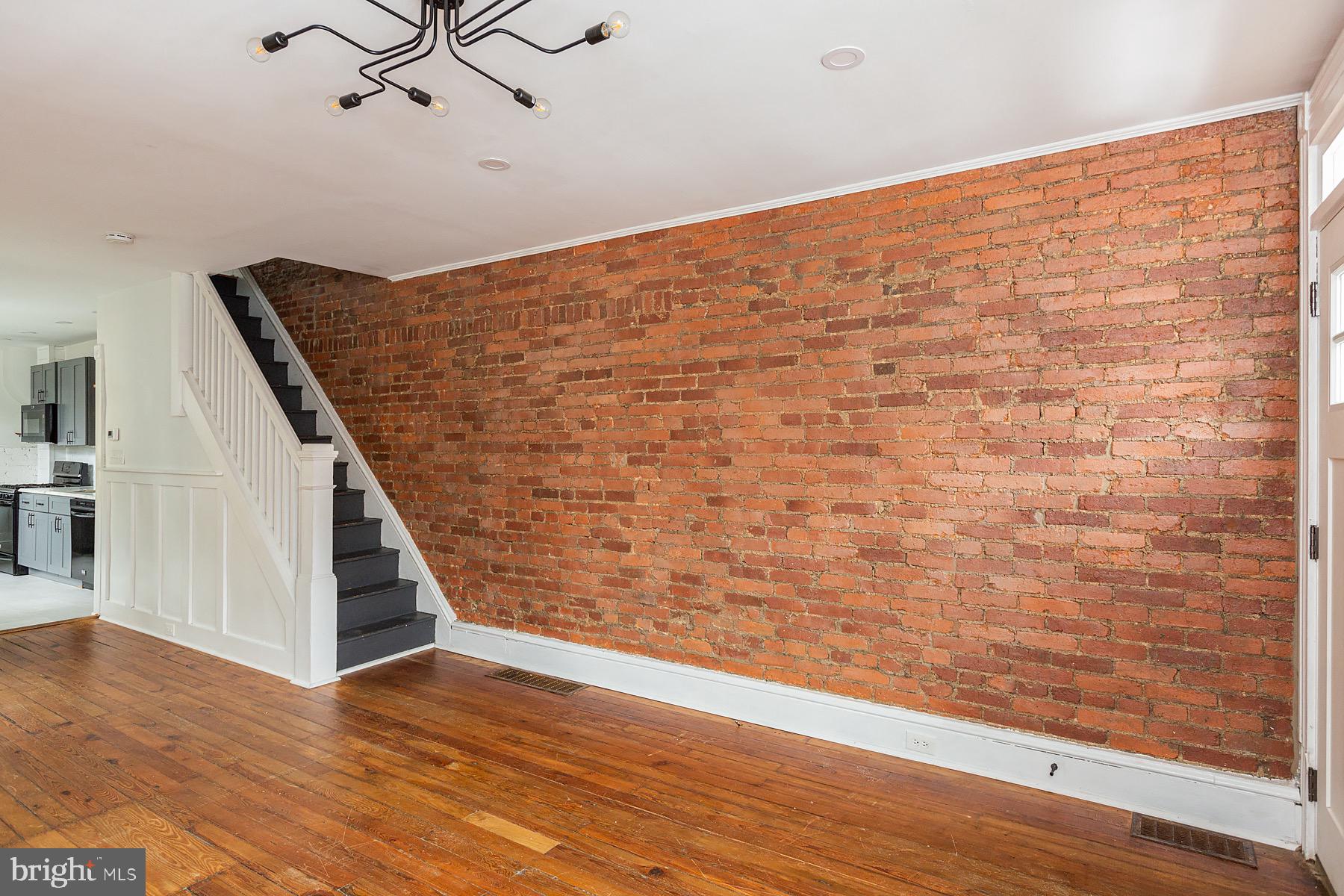 138 Laurel Street Lancaster, PA 17603 - Photo 5 of 42 a view of an empty room with wooden floor and stairs