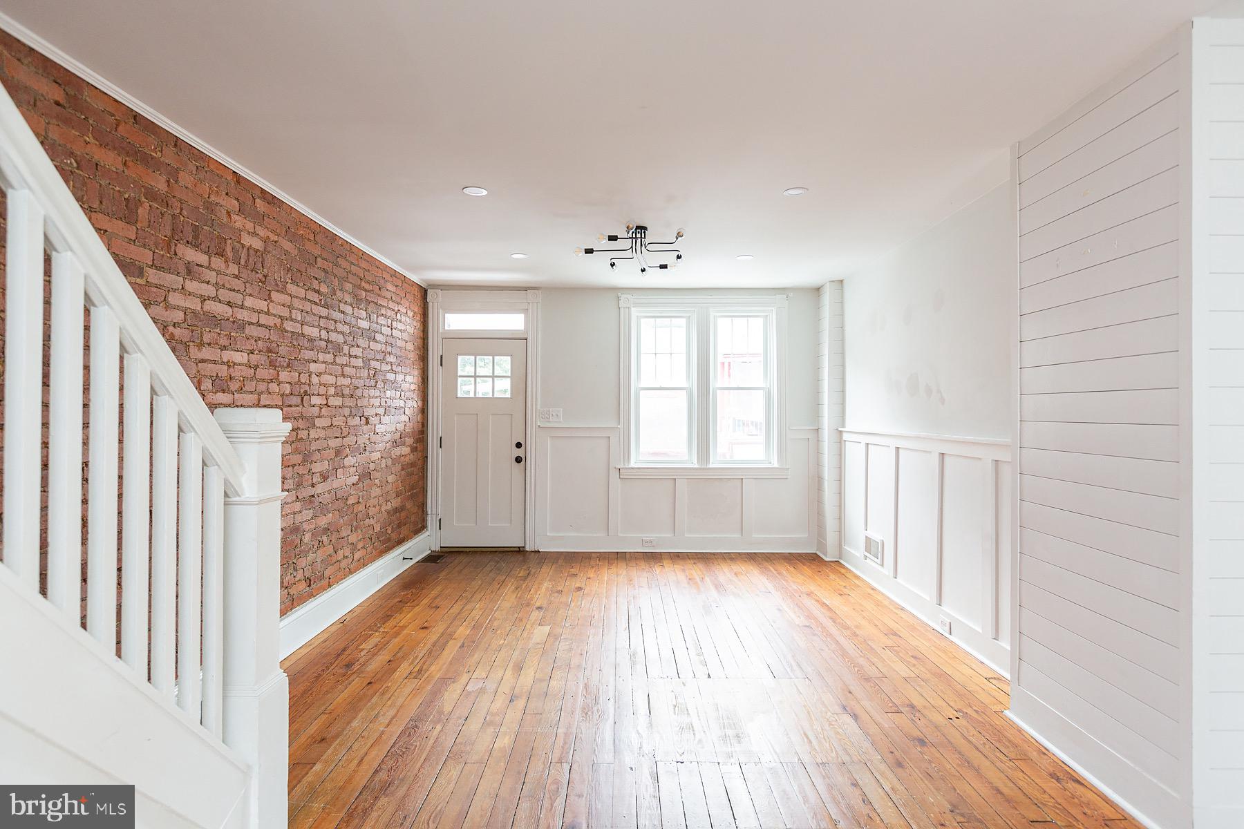 138 Laurel Street Lancaster, PA 17603 - Photo 6 of 42 a view of an empty room with wooden floor and a window