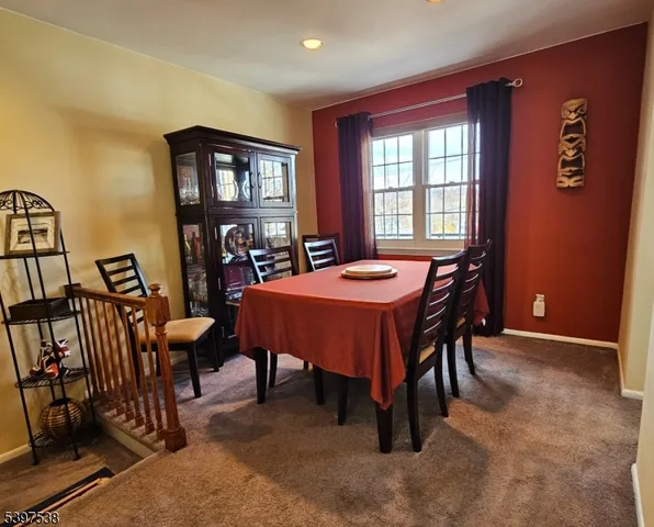 a view of a dining room with furniture and window