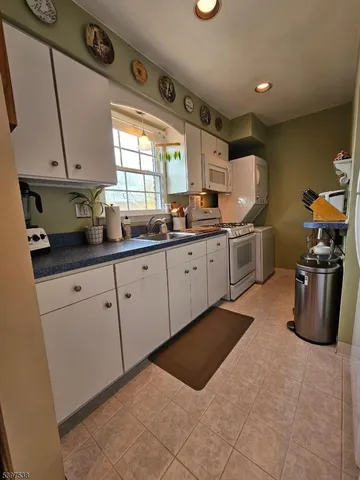 a kitchen with sink cabinets and window
