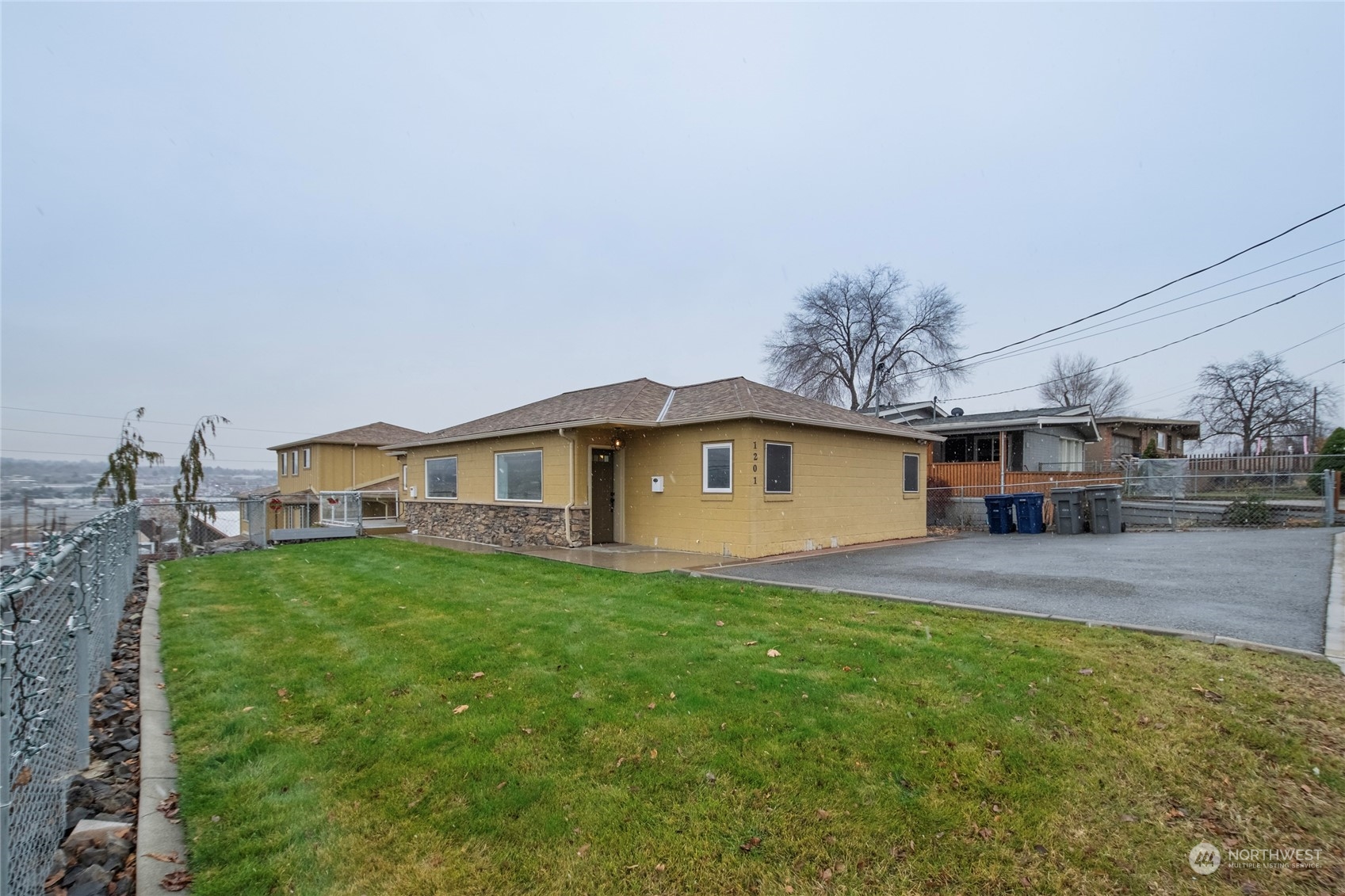1201 Monitor Avenue Wenatchee, WA 98801 - Photo 18 of 24 a view of a yard in front of a house with large trees