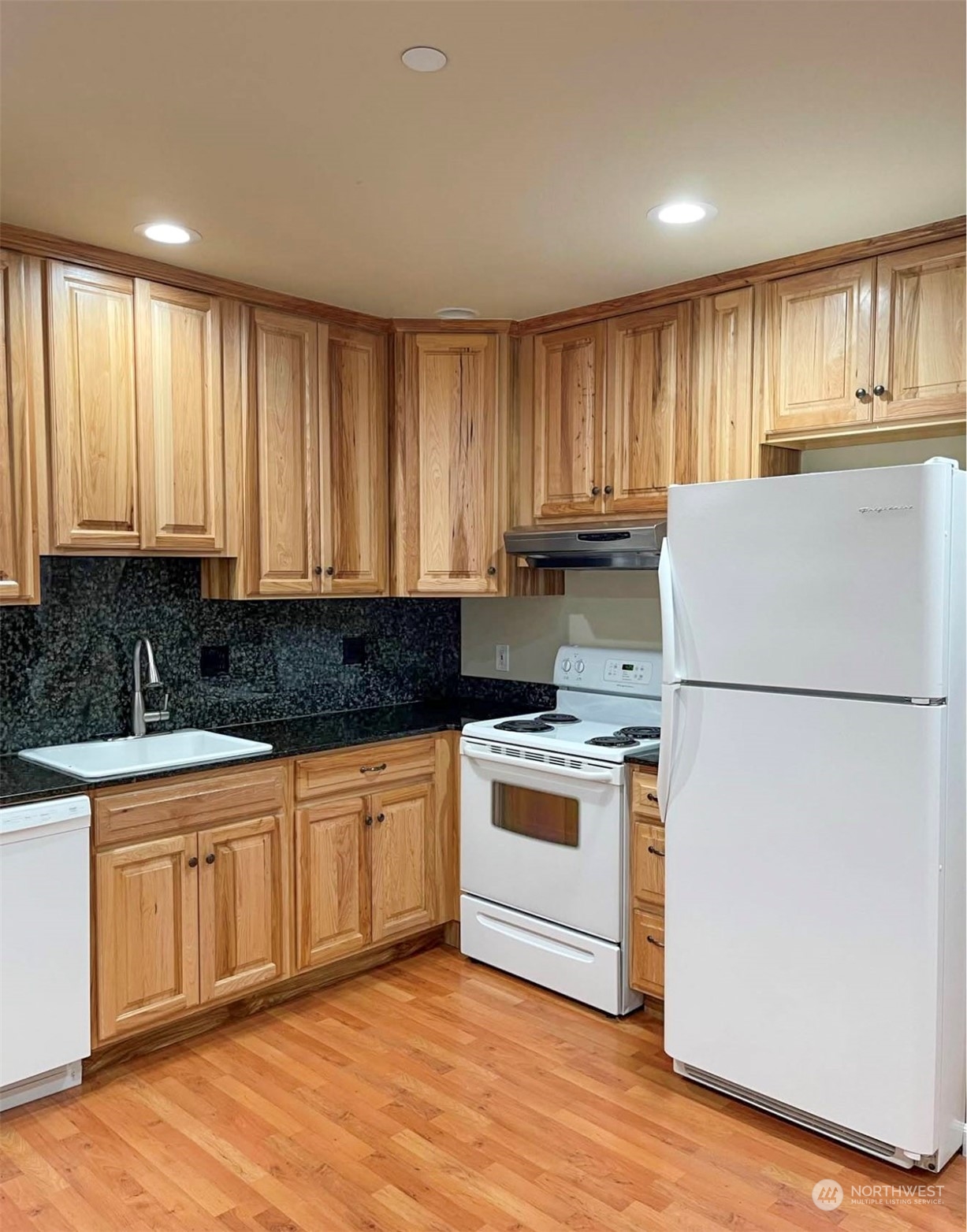 1201 Monitor Avenue Wenatchee, WA 98801 - Photo 7 of 24 a kitchen with a refrigerator a stove a sink and cabinets