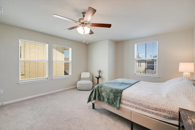 a bedroom with a two bed and window