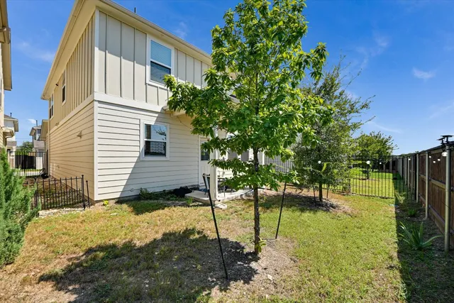 a view of a house with backyard and sitting area