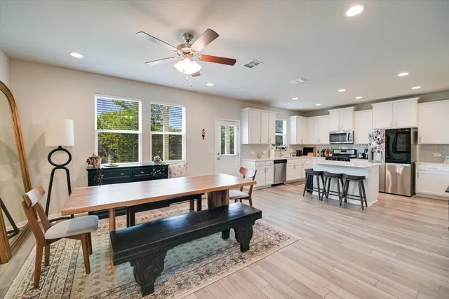 a large kitchen with a table and chairs