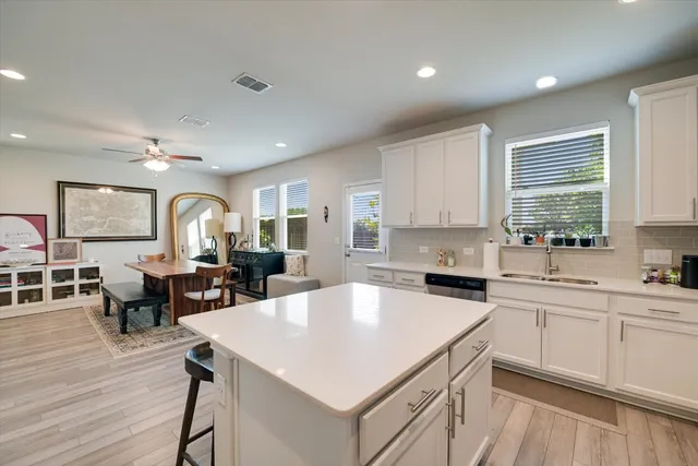 a kitchen with a stove a sink a dining table and chairs