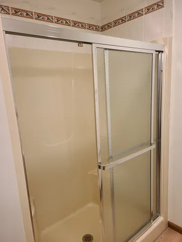 a bathroom with a glass shower door