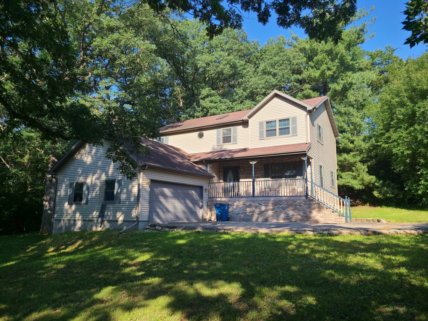 2871 East 777th Road Utica, IL 61373 - Photo 13 of 19 a front view of a house with a garden