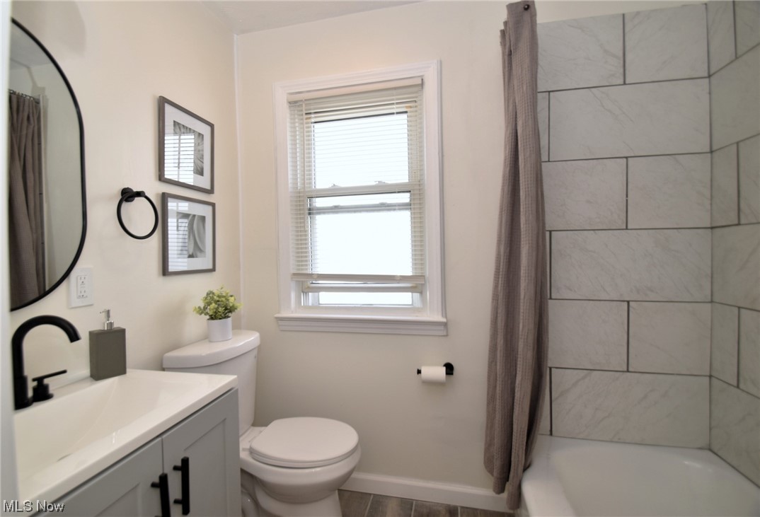 1259 Churchill Road Cleveland, OH 44124 - Photo 15 of 24 Full bathroom featuring vanity with extensive cabinet space, plenty of natural light, shower / bathtub combination with curtain, and mirror