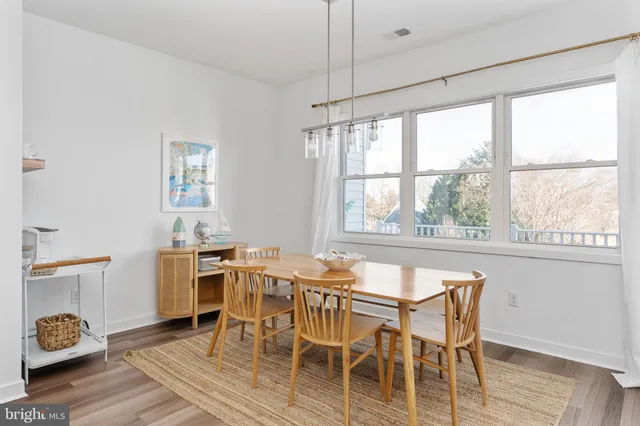 a dining room with furniture and wooden floor