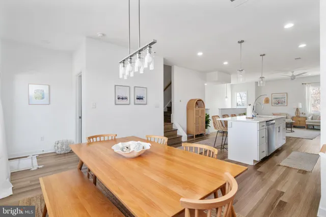 a kitchen with stainless steel appliances kitchen island granite countertop a sink and a refrigerator