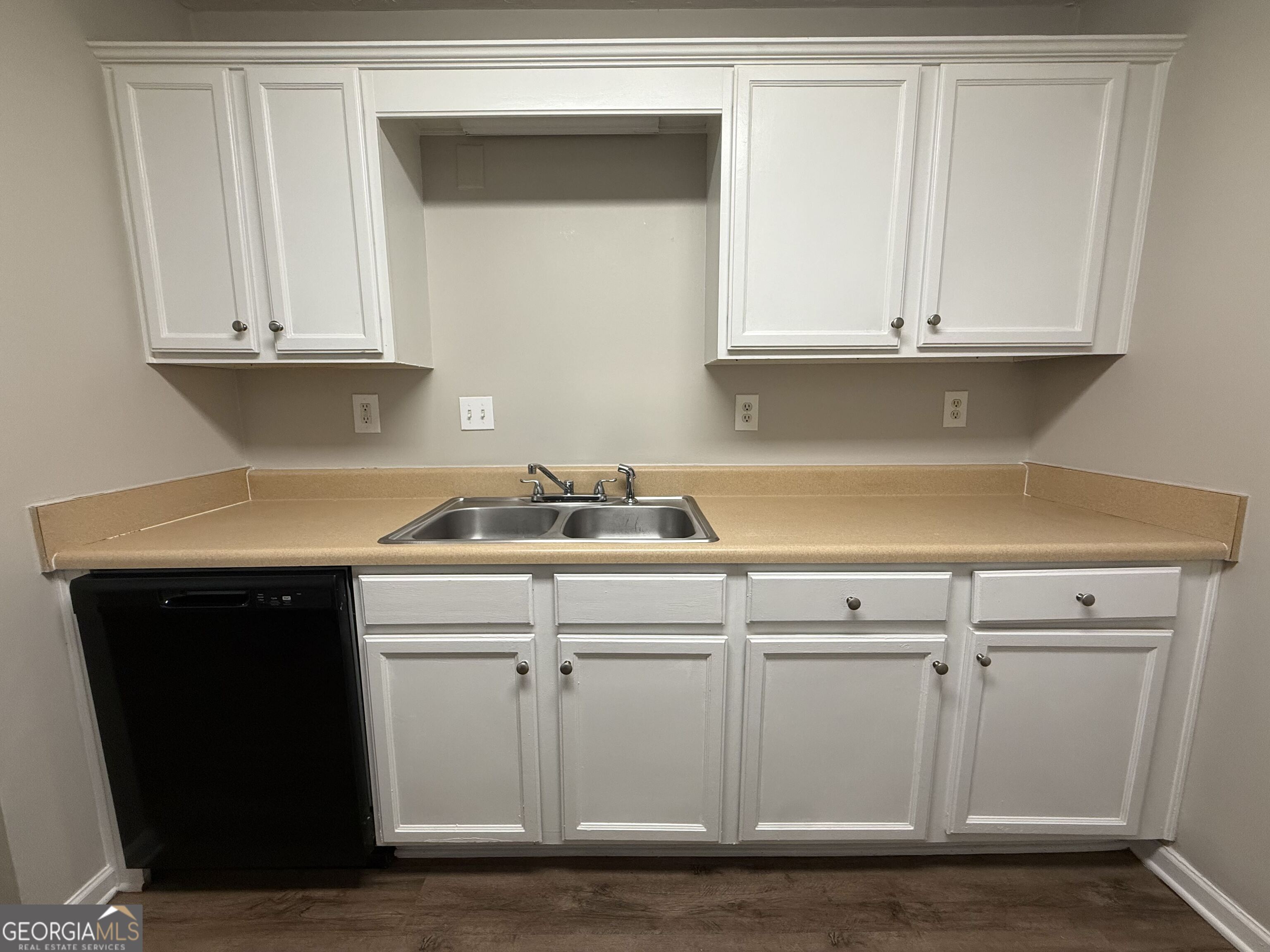 6132 Ruth Street Southwest Covington, GA 30014 - Photo 14 of 33 a kitchen with white cabinets and sink