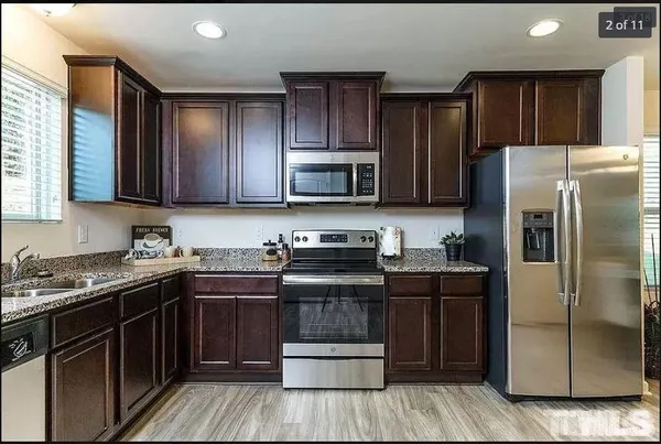 a kitchen with a sink stove and refrigerator