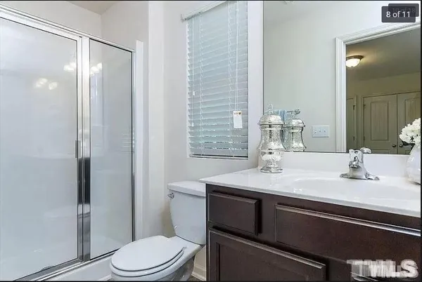 a bathroom with a sink toilet vanity and shower