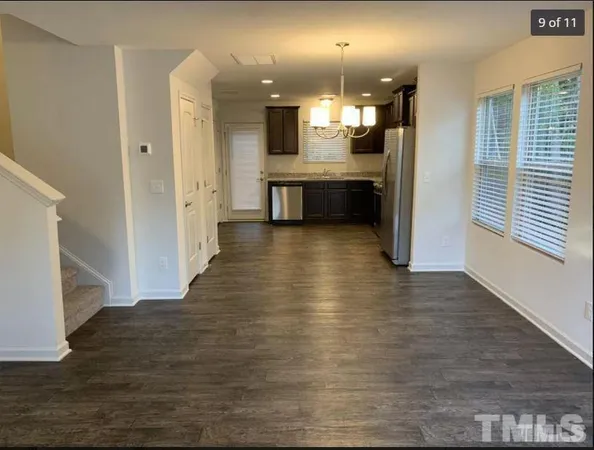 a view of a kitchen with wooden floor and a kitchen