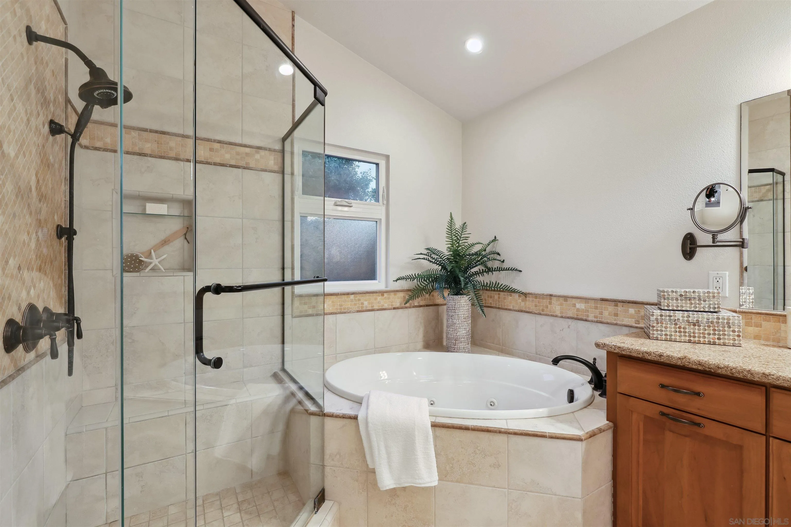 1449 Rainbow Ridge Lane Encinitas, CA 92024 - Photo 21 of 58 a bathroom with a tub sink and mirror
