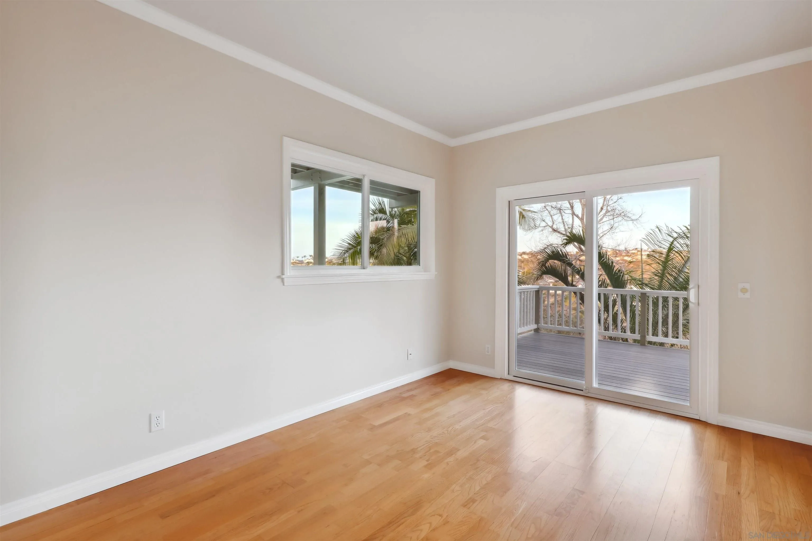 1449 Rainbow Ridge Lane Encinitas, CA 92024 - Photo 27 of 58 an empty room with wooden floor and windows