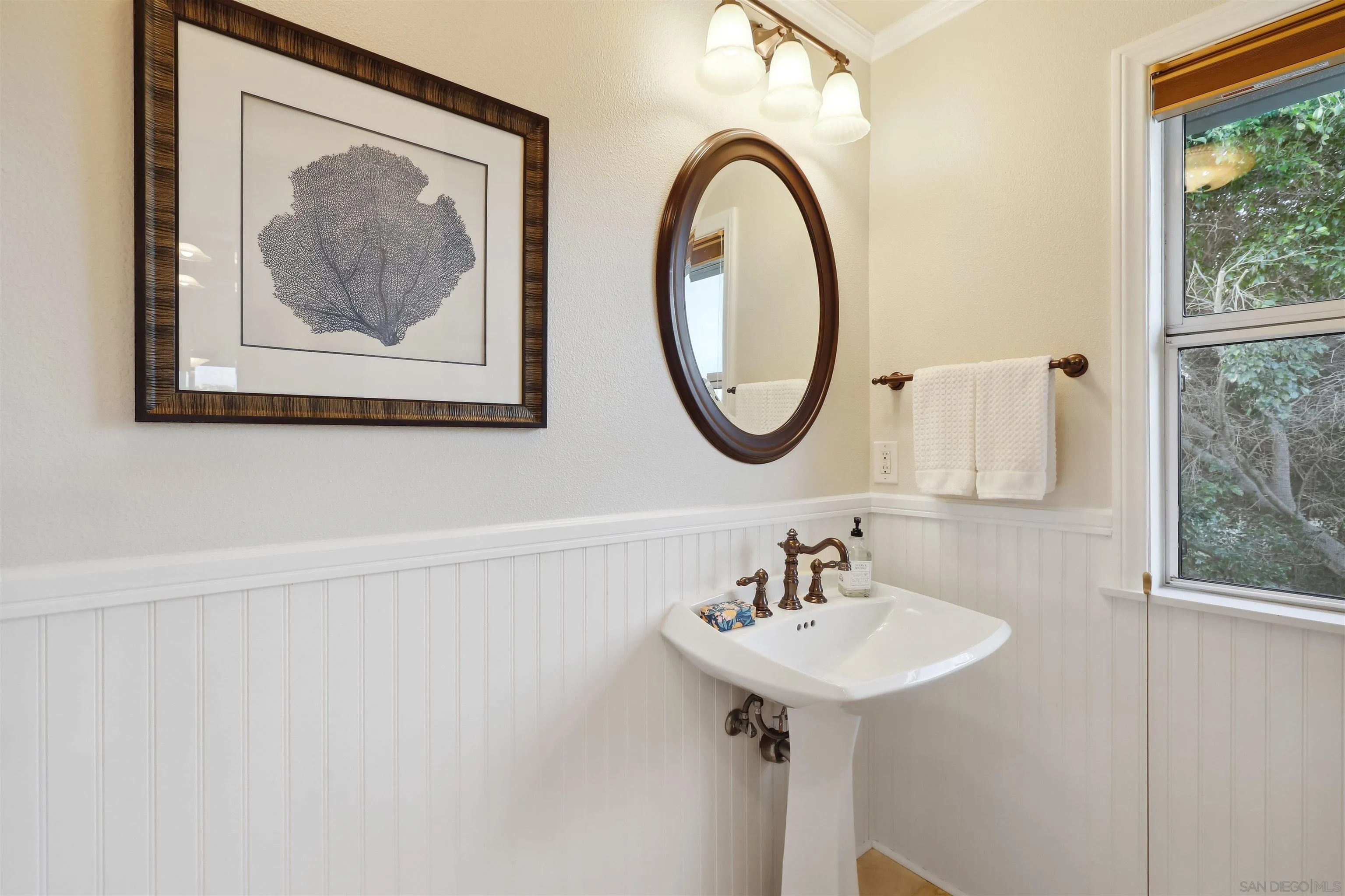 1449 Rainbow Ridge Lane Encinitas, CA 92024 - Photo 29 of 58 a bathroom with a sink and a mirror