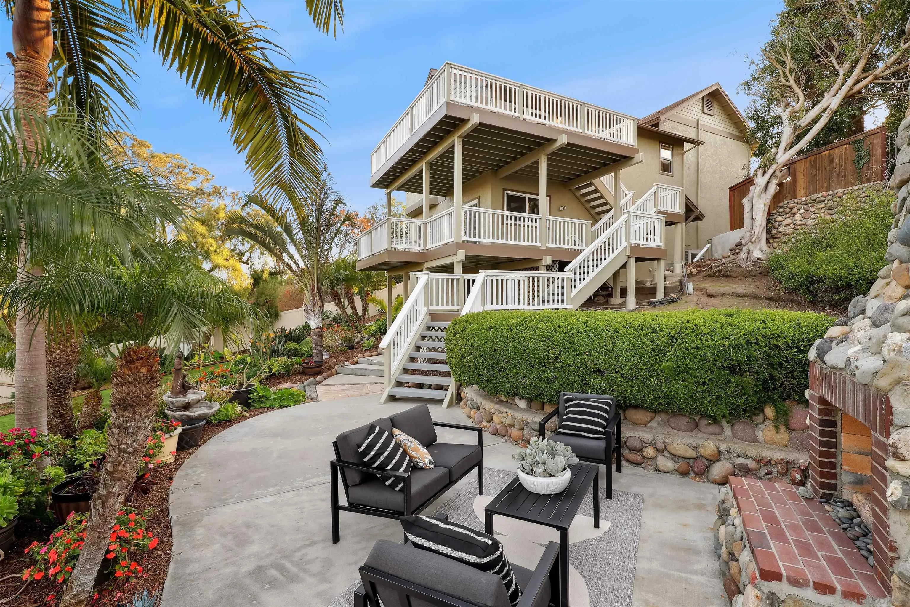 1449 Rainbow Ridge Lane Encinitas, CA 92024 - Photo 31 of 58 a view of a patio with table and chairs with wooden fence and plants