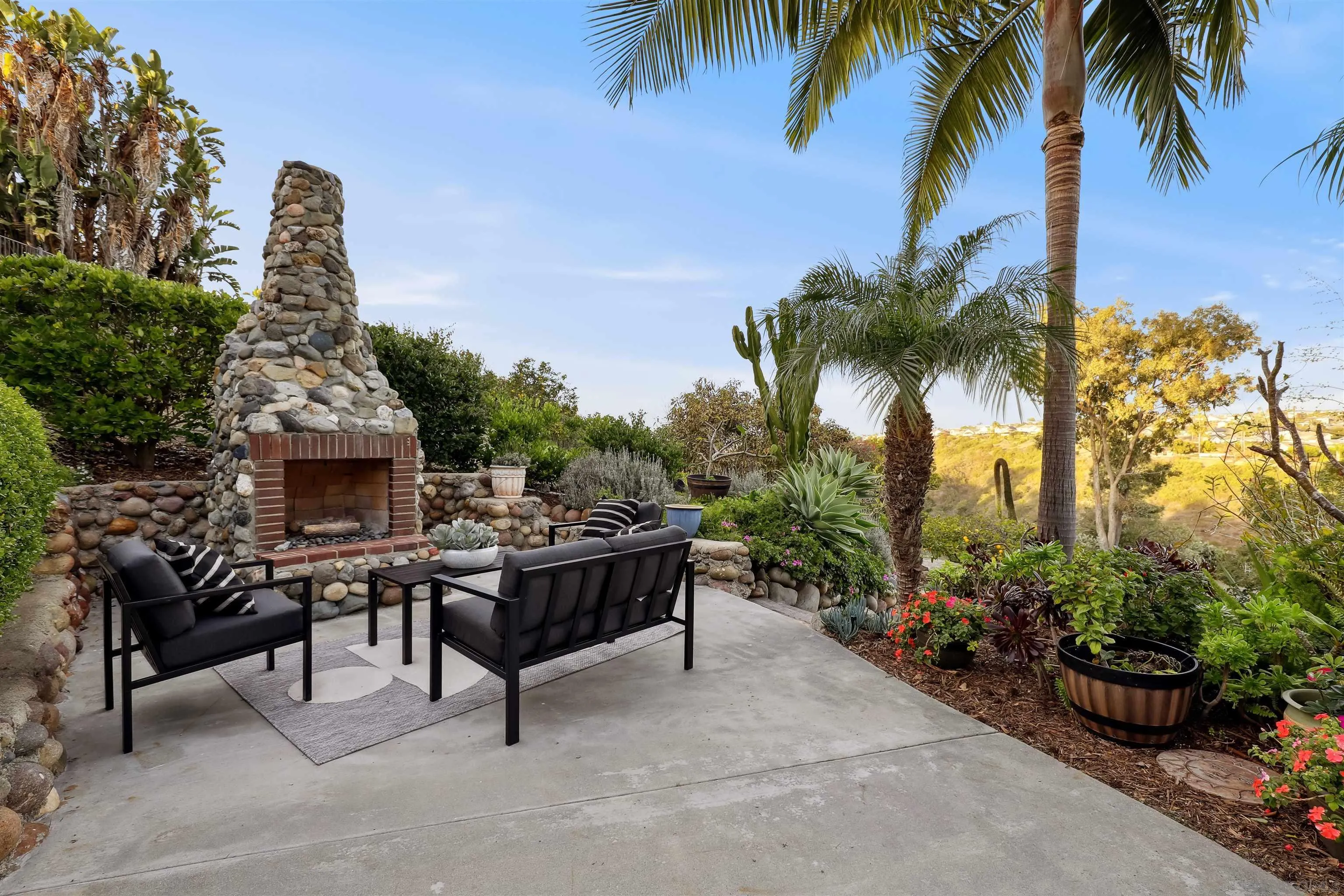 1449 Rainbow Ridge Lane Encinitas, CA 92024 - Photo 32 of 58 a view of a house with a garden and potted plants