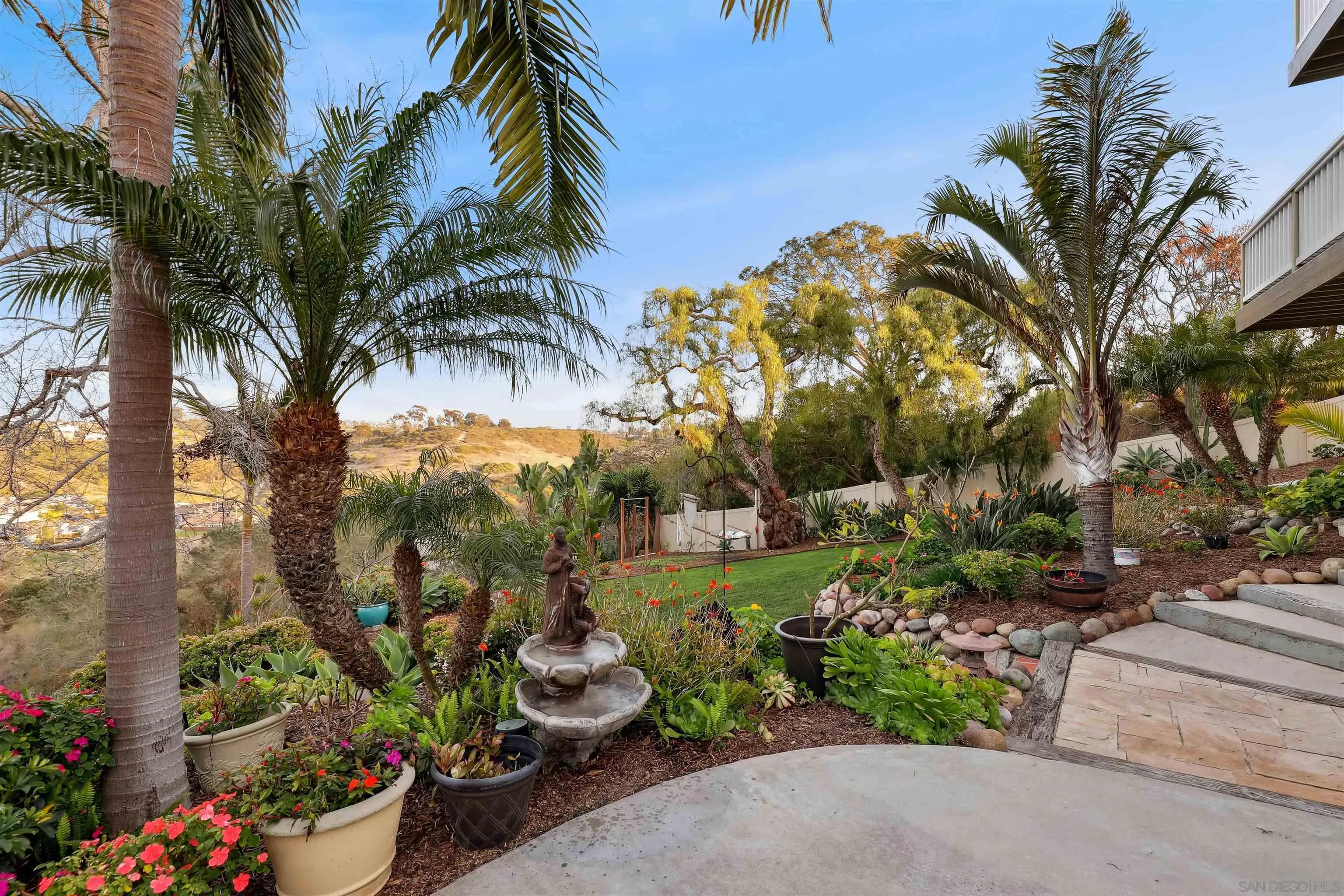 1449 Rainbow Ridge Lane Encinitas, CA 92024 - Photo 35 of 58 a view of a garden with a fountain and potted plants