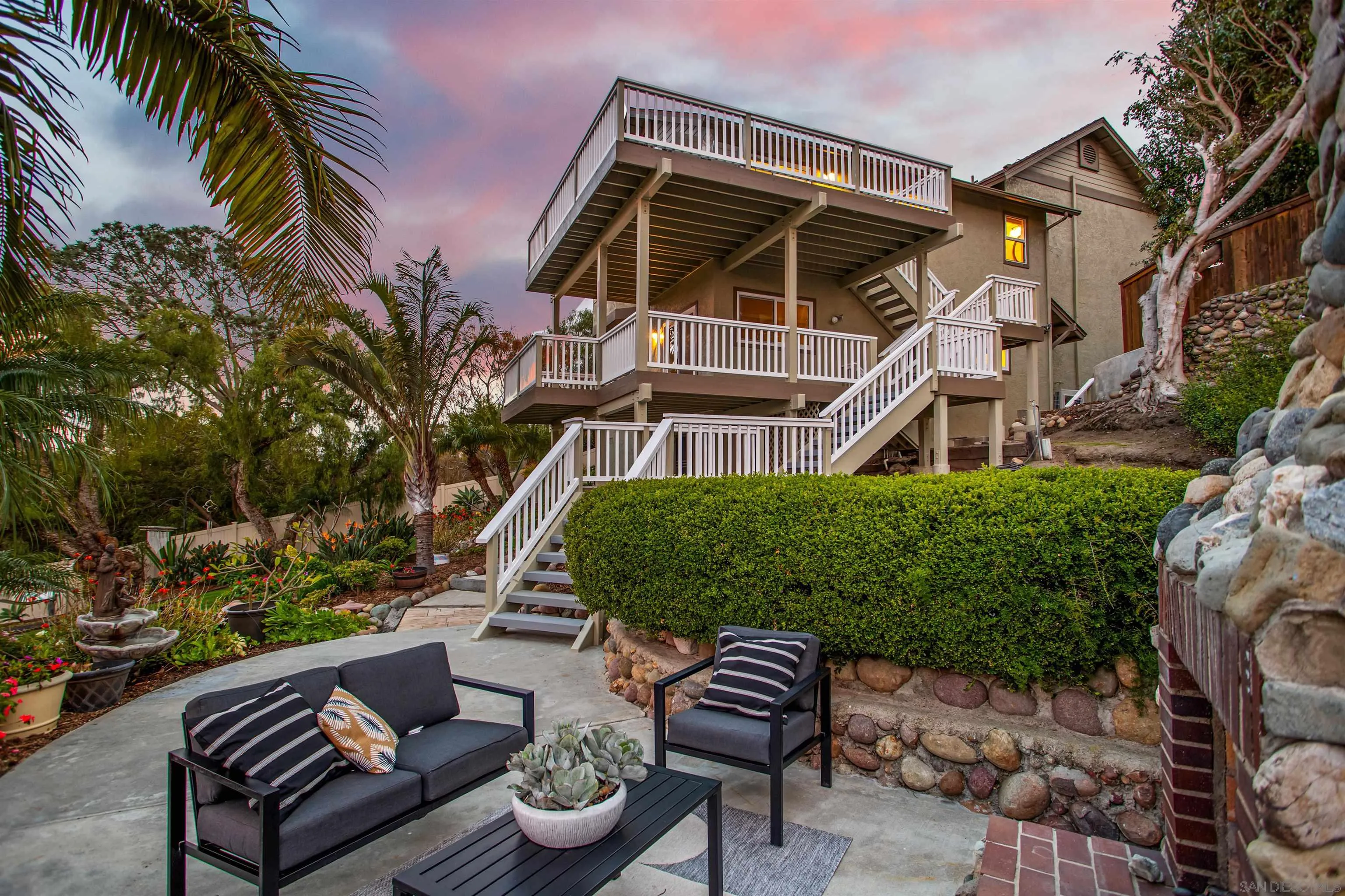 1449 Rainbow Ridge Lane Encinitas, CA 92024 - Photo 50 of 58 a view of a patio with couches table and chairs and potted plants