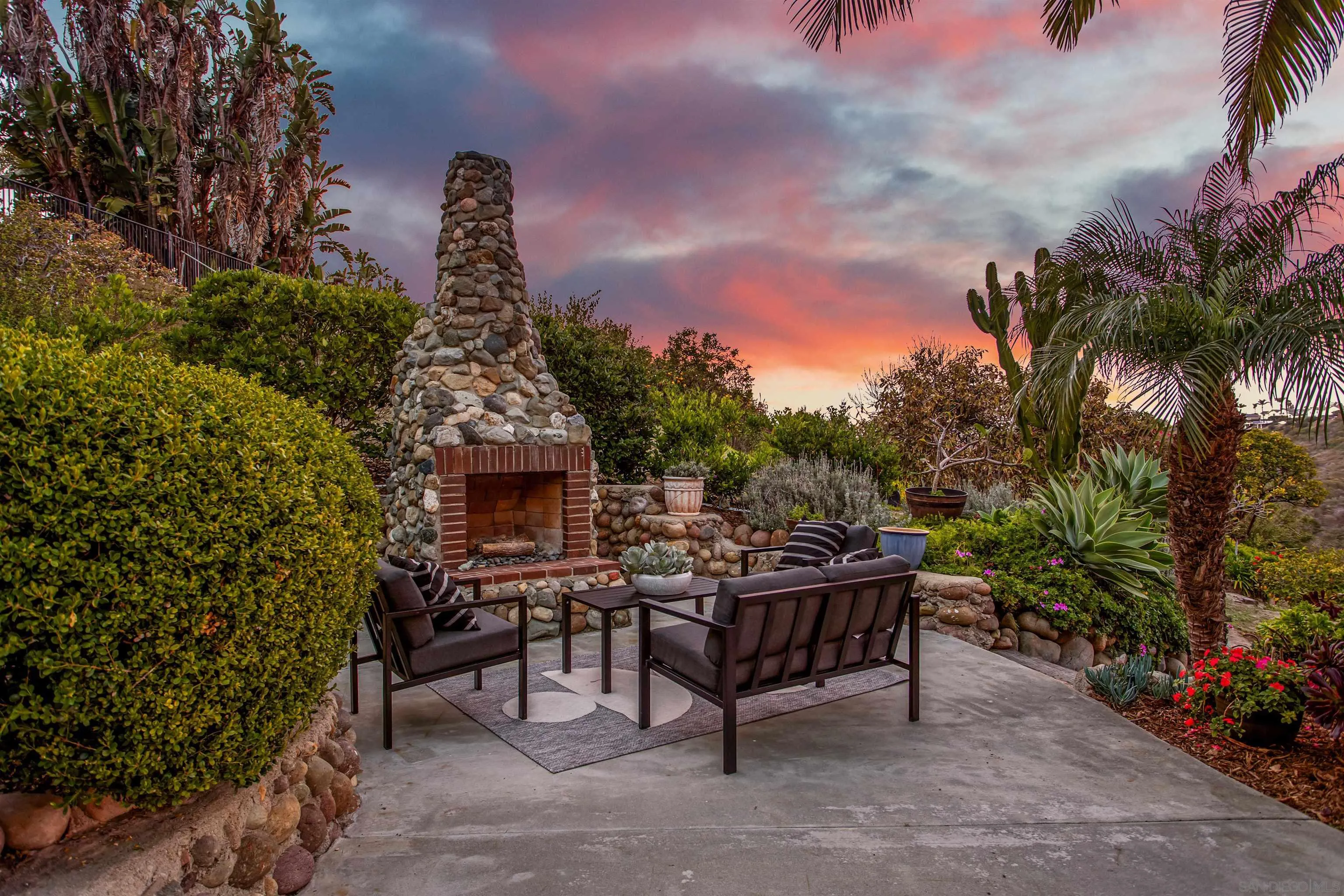 1449 Rainbow Ridge Lane Encinitas, CA 92024 - Photo 51 of 58 a view of a dinning table and chairs in patio