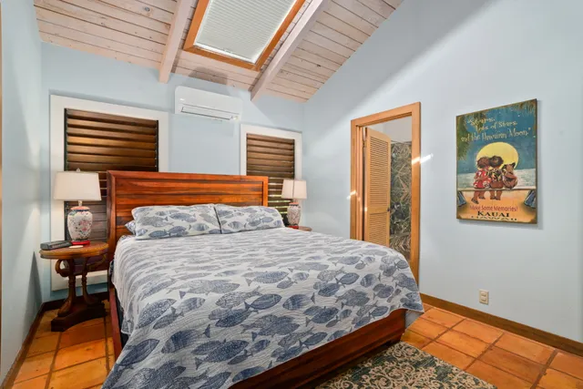 a bedroom with double bed and a window