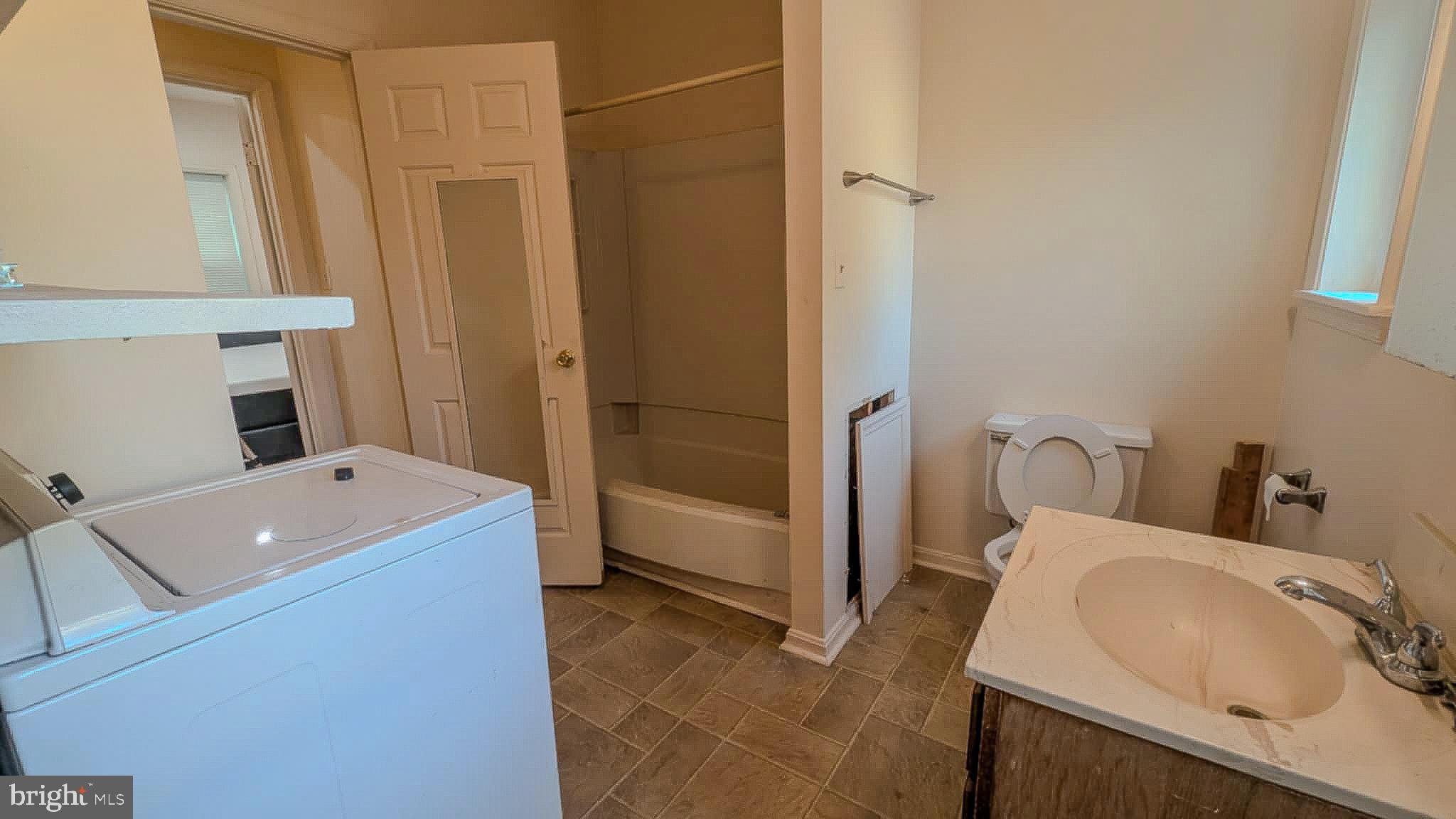 209 Penn Street Baltimore, MD 21201 - Photo 11 of 22 a bathroom with a sink and a shower