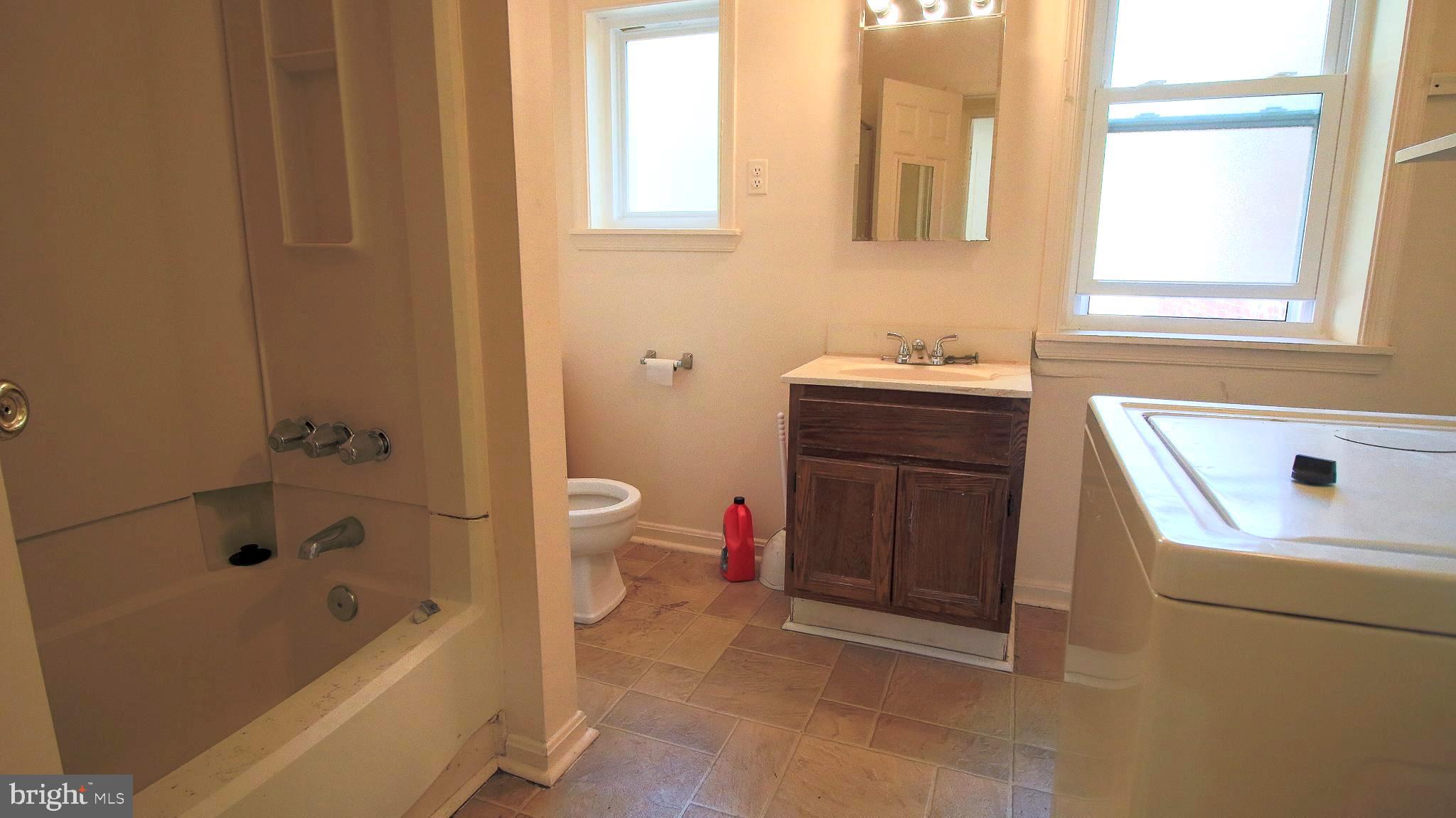 209 Penn Street Baltimore, MD 21201 - Photo 13 of 22 a bathroom with a sink a toilet and bathtub