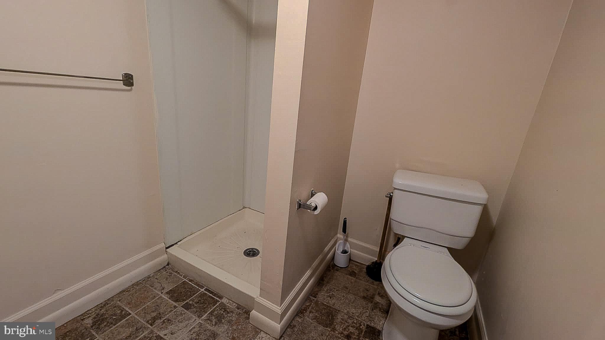 209 Penn Street Baltimore, MD 21201 - Photo 17 of 22 a bathroom with a toilet and a shower