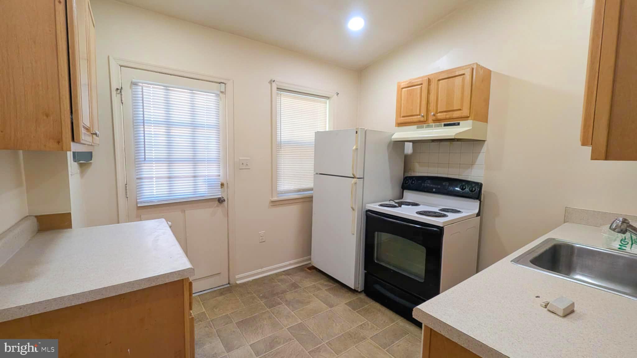 209 Penn Street Baltimore, MD 21201 - Photo 5 of 22 a kitchen that has a sink and a stove in it