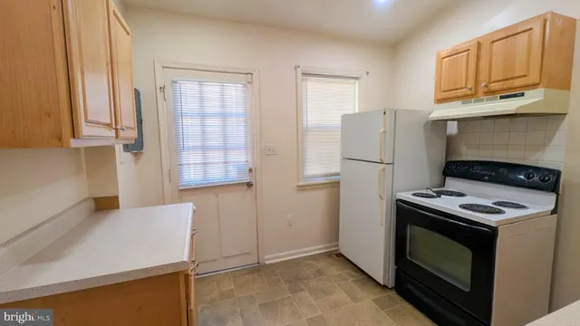a kitchen with a stove and a refrigerator
