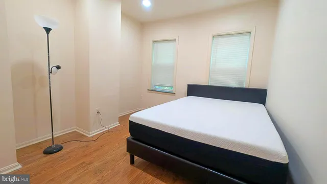 a bed sitting in a bedroom next to a window