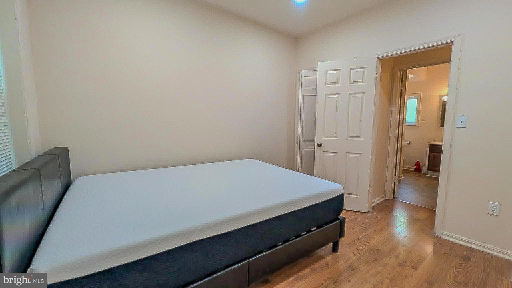 209 Penn Street Baltimore, MD 21201 - Photo 9 of 22 a room with a bed and wooden floor