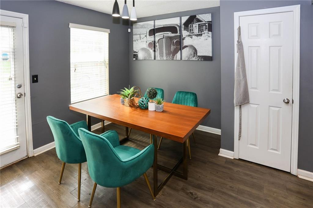 5854 El Segundo Way Atlanta, GA 30349 - Photo 14 of 63 a view of a dining room with furniture and wooden floor